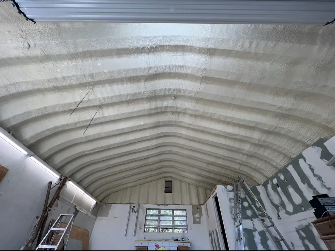 Spray polyurethane foam applied to the underside of a metal roof deck in DuPont